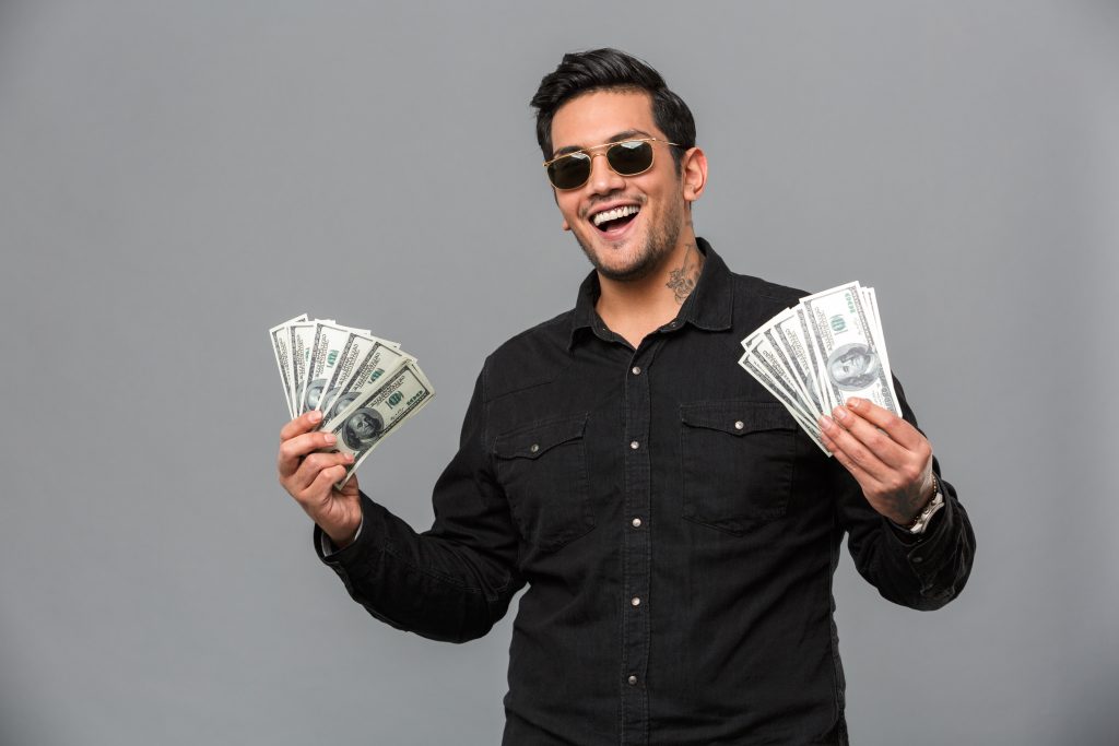 excited-young-handsome-man-holding-money-1024x683.jpg